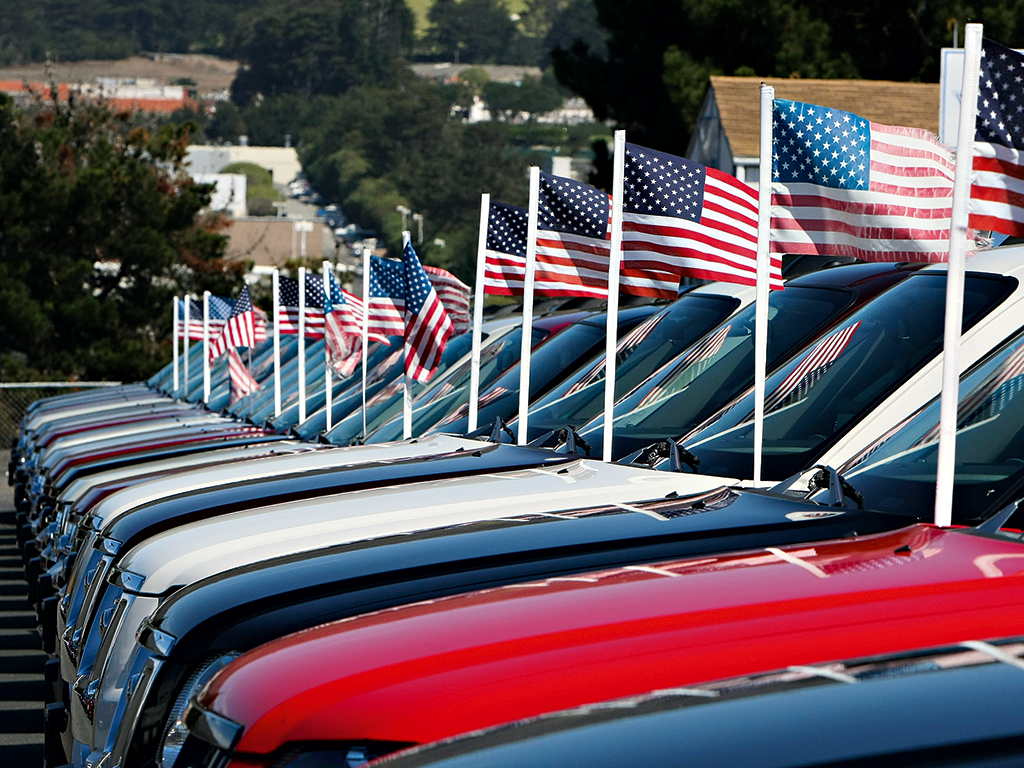 Brand new, patriotic Ford pickup trucks in Colma, California. Auto dealers are large donors to US political campaigns 