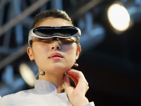 A South Korean model sports a piece of wearable technology. Defining technology has been a challenge for economists and theorists, due to the many things the word encompasses